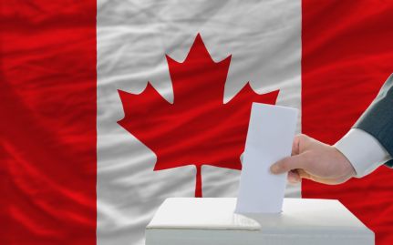 man-putting-ballot-in-a-box-during-elections-in-canada